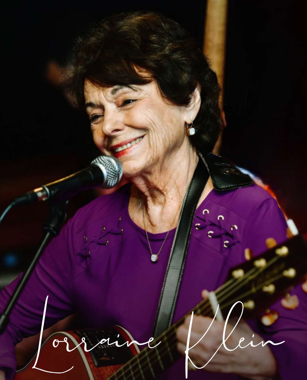 Lorraine Klein singing and playing guitar